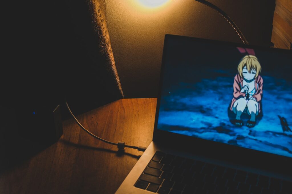 a laptop computer sitting on top of a wooden desk